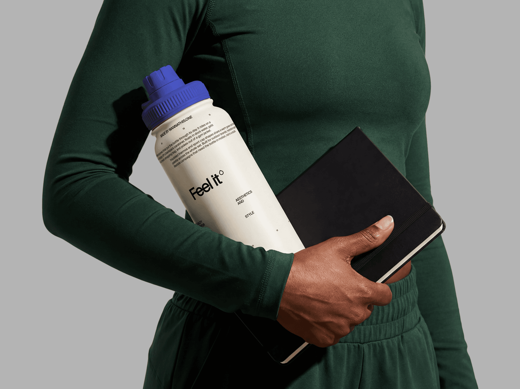Travel bottle mockup carried alongside an open notebook in a refined wellness office lifestyle scene