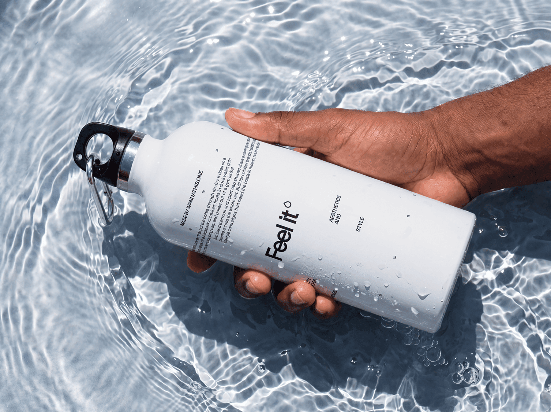 Travel bottle mockup held above a glassy water surface with refined realistic reflections in studio scene