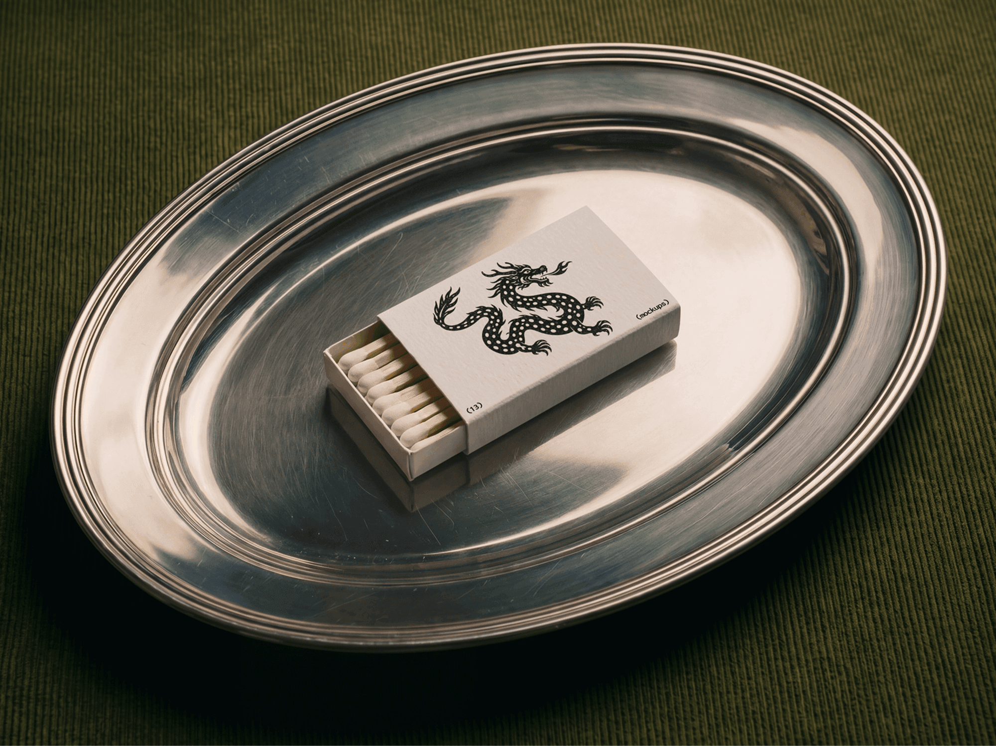 Single partly open vintage matchbox centred on a round metal serving tray