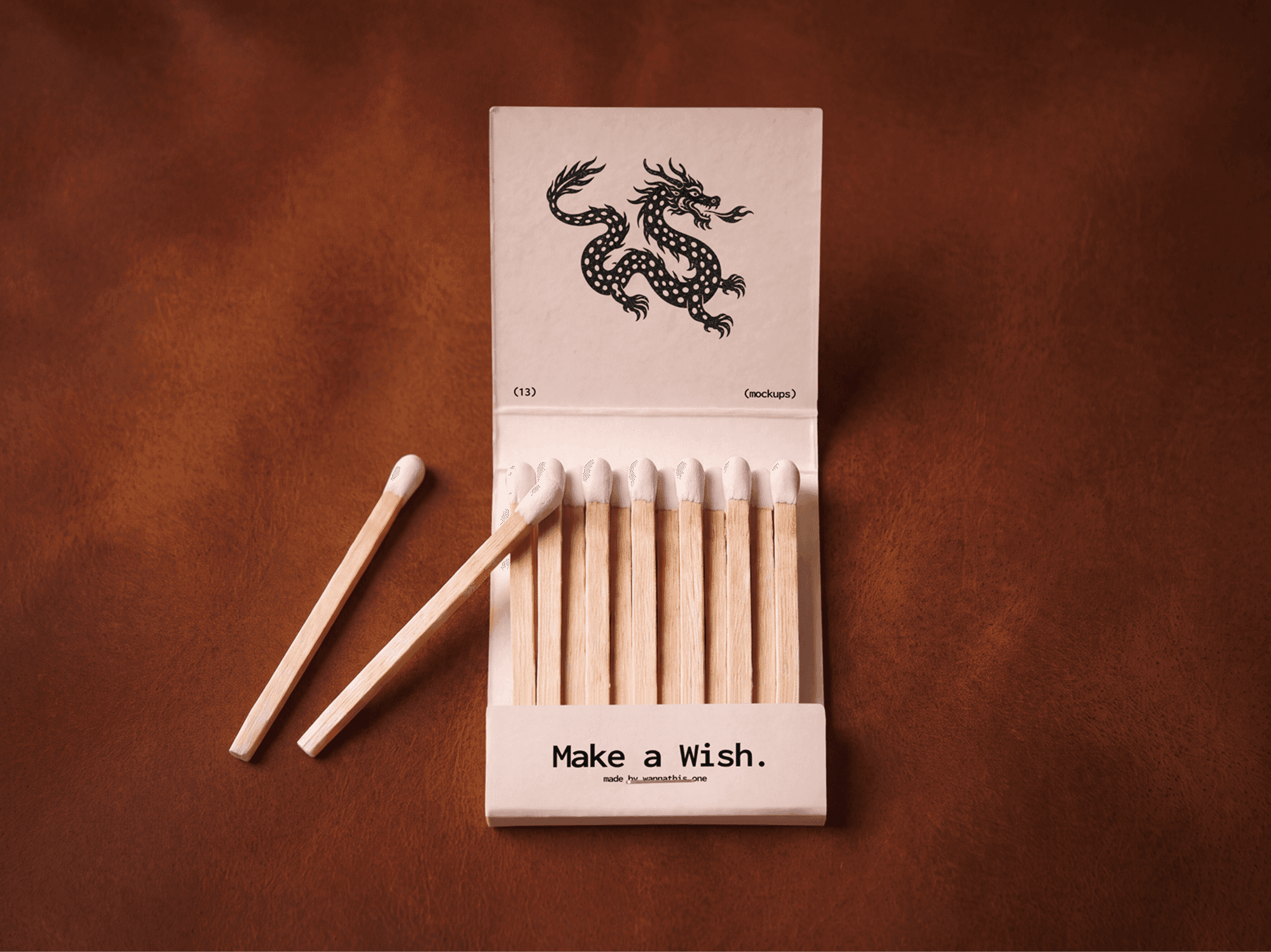 Open vintage matchbox full of matches with two loose matches laid beside the box