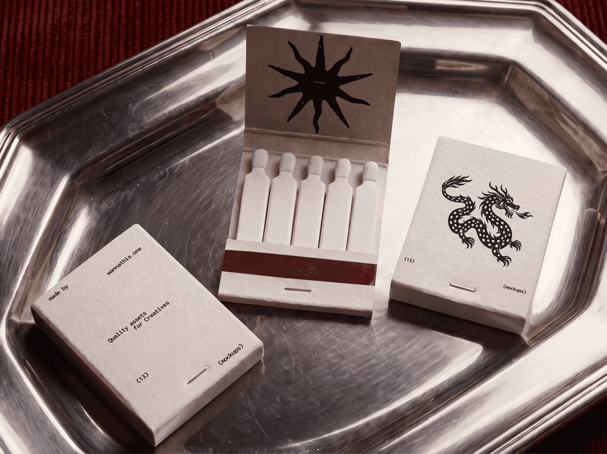 Several vintage matchboxes, some open and some closed, arranged on a metal tray