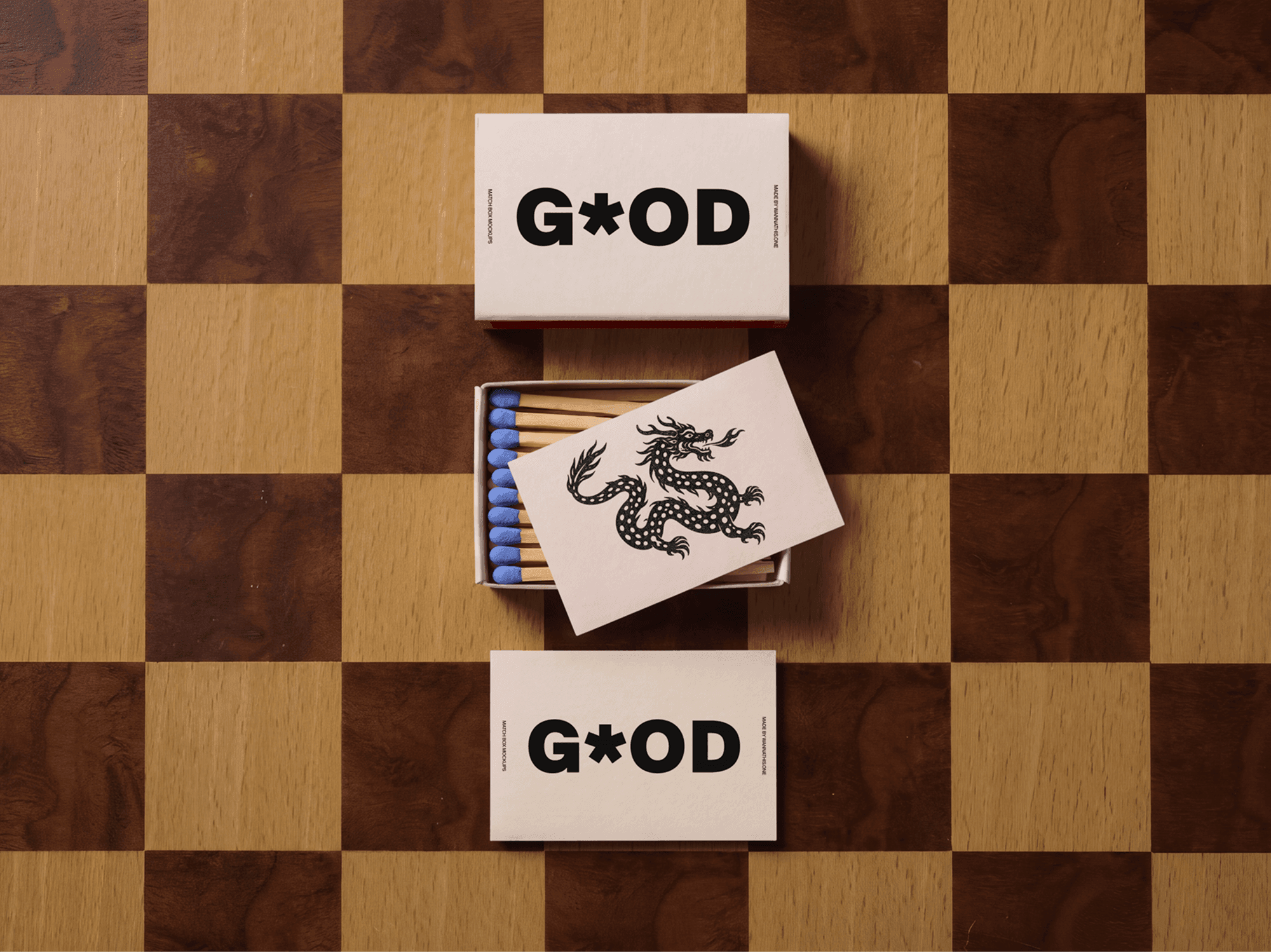 Open and closed vintage matchboxes arranged across a black and white checkerboard