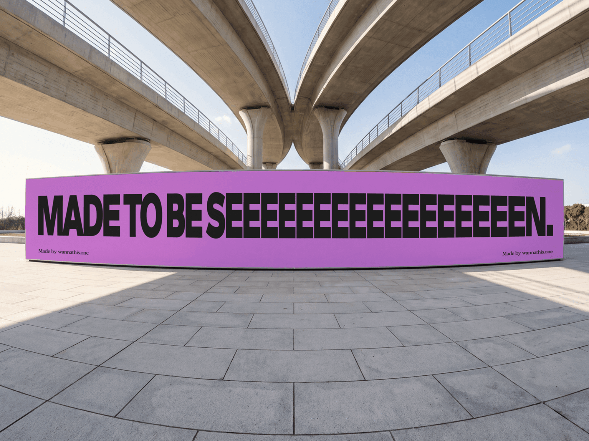 Wide billboard standing in open ground beneath elevated concrete road bridges