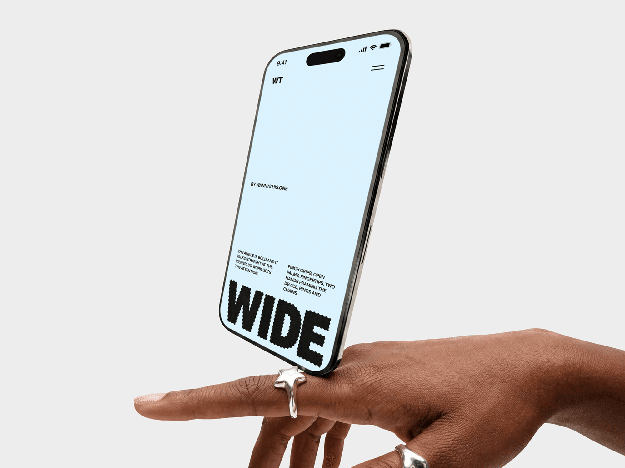 iPhone mockup balanced on a single hand against a plain studio background