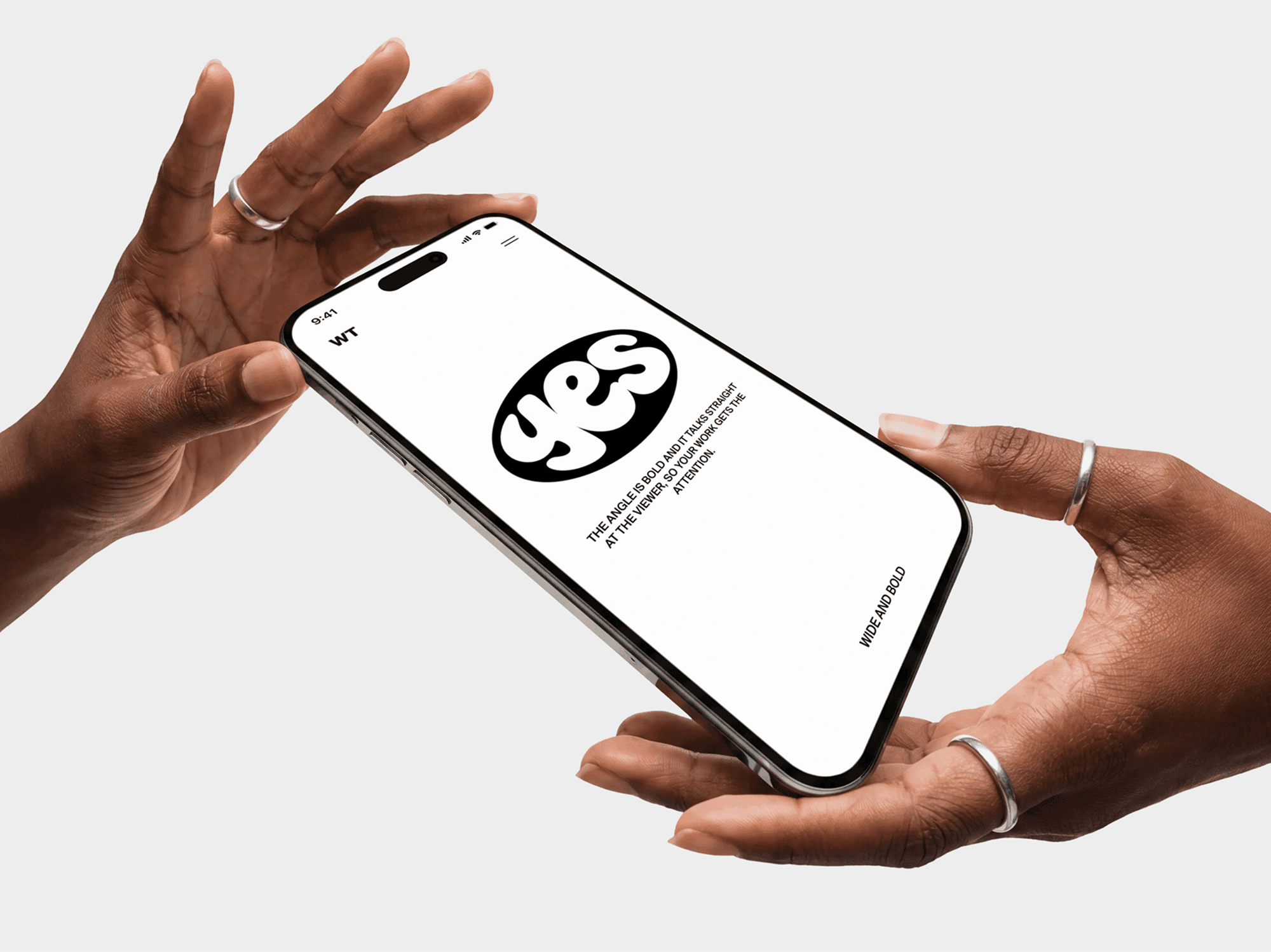 iPhone mockup gripped at one corner with an open palm held alongside the screen