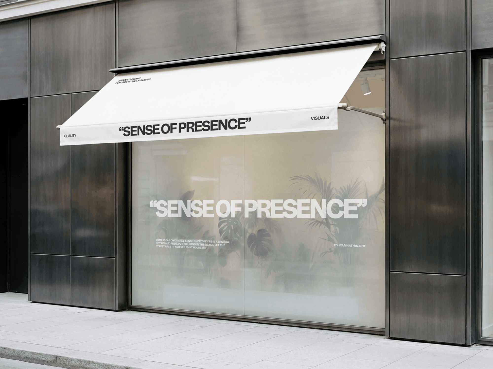 Storefront window signage mockup with a soft fabric awning above the glass in a refined retail street scene